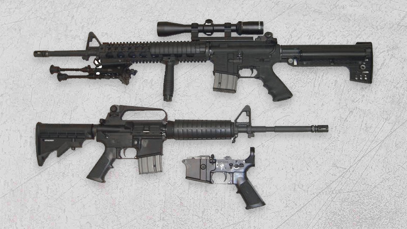 Two black AR-15 rifles placed on a white background