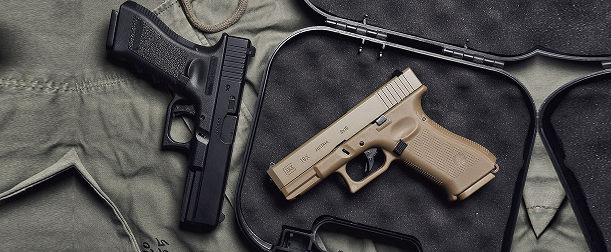 9mm Glock handgun in black and brown and a holster placed on a table