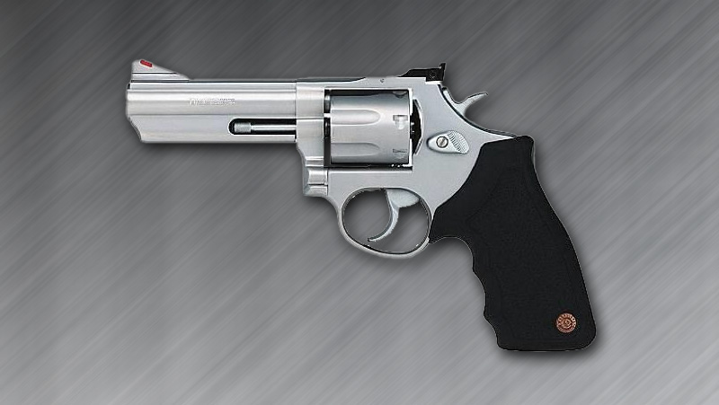 A 9mm Smith & Wesson M&P revolver on a gray background