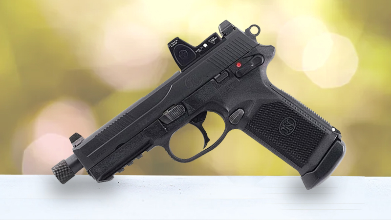 A black handgun rests on a table, with a softly blurred background enhancing the focus on the firearm