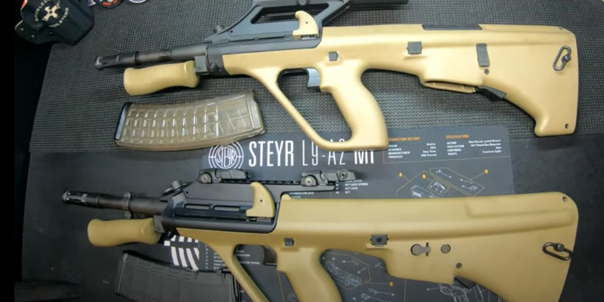 Two tan firearms placed on a table alongside a magazine, showcasing a simple yet striking arrangement